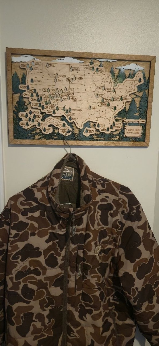 Drake Waterfowl Lightweight Packable Jacket hanging up, showing the old-school camo pattern in detail