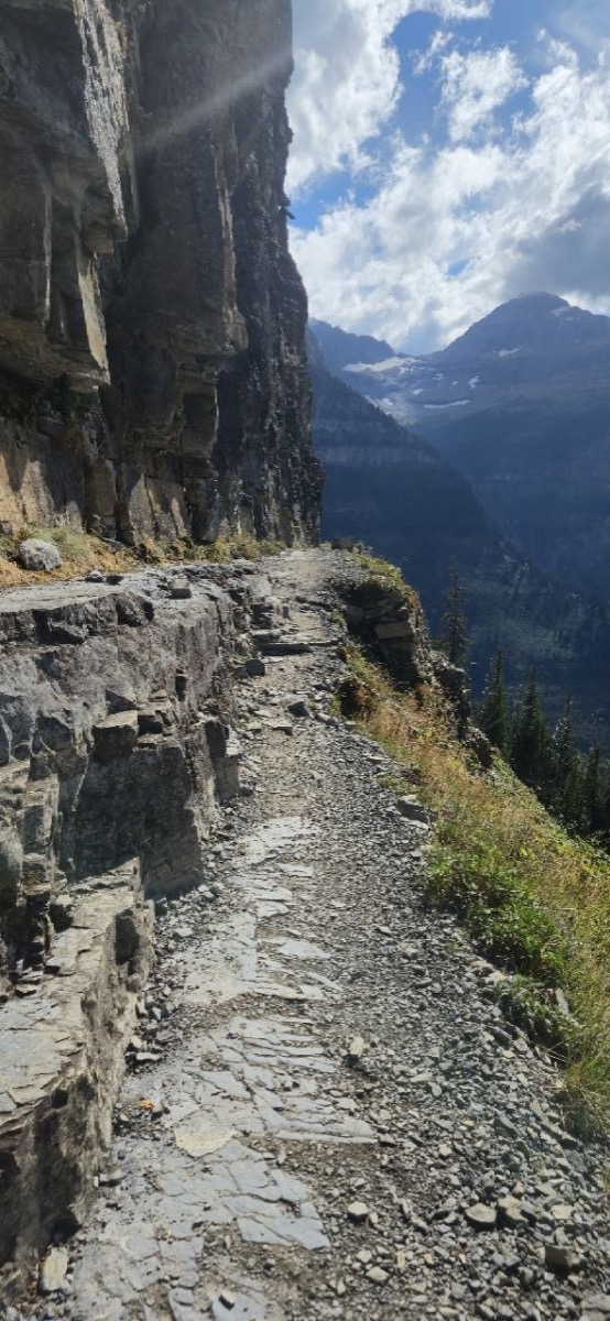 The narrow ledge trail along the Garden Wall on the Highline Trail, cut into the cliff face