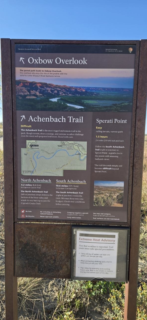 The Oxbow Overlook trailhead sign, showing the junction for Achenbach Trail, Sperati Point, and an active Extreme Heat Advisory posting.